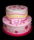 Pink Bowtie Birthday Cake,  Pink buttercream iced, 2 round tiers decorated with dots, pink and yellow pearls, and a pink bowtie. Everything on this cake is EDIBLE.  (Serves 28-55 party slices)